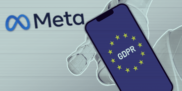 Robot hand clutching phone with GDPR/EU flag on it, Meta logo in background