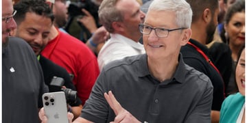 Tim Cook holds iPhone