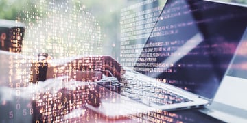 Concept picture of coding in skull shape over reporter typing on laptop
