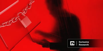 chain lock on a laptop and a shadow of a man with a laptop in the background