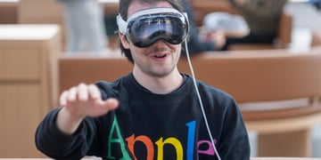 Man wears Apple augmented/virtual reality headset in Apple sweat shirt