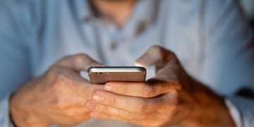 zoom in male hands operating smartphone