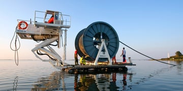 workers laying undersea cable