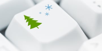Christmas tree and snowflakes printed on white computer keyboard