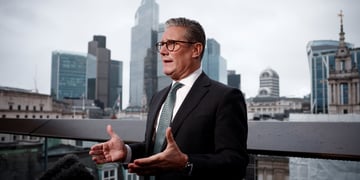 UK Prime Minister Keir Starmer speaking, cityscape in the background