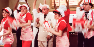 The KFC staff and Colonel Sanders in an ad.