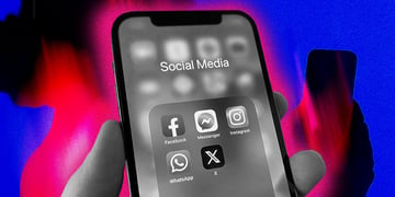 A phone with social media apps, under a colorful scrutiny.