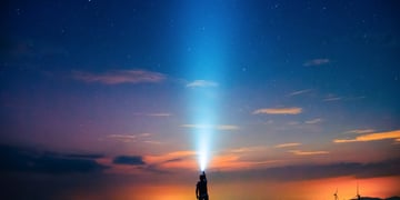 A light being shone on a beautiful night sky.