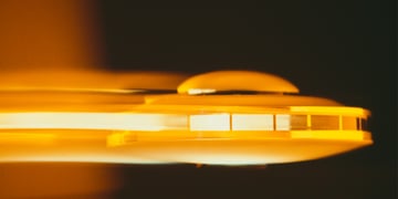 A retro photo of a UFO travelling past.