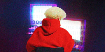 blonde hacker on a laptop with red jumper