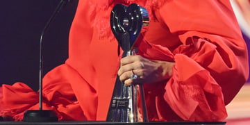 Lady Gaga holds an iHeartRadio award