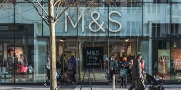 m&s store, big front sign, people on the street, a tree