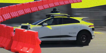A Waymo self-driving car; road barriers