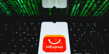 aliexpress app app open on phone, on black laptop and green numbers