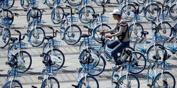 china, blue hello bikes, one cyclist, white hat
