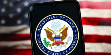 department of state logo, eagle in centre, us flag in the back, phone screen