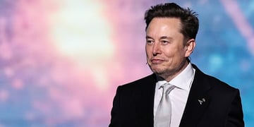 Elon musk wearing a suit in pink and purple background