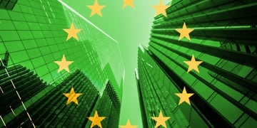 EU flag yellow stars in circle over a city, buildings in green