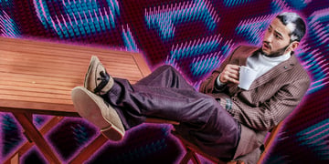 man with feet on-the table-numbers in the back, white coffee mug