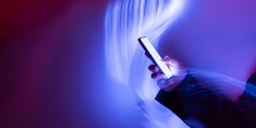 phone in had surrounded with wave of blue light