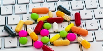 Pills on a keyboard.