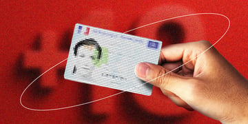 personal id card from france held in hand, blurry female face, +18 in the background