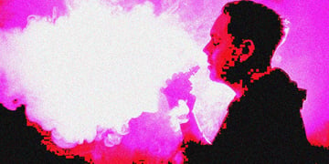 A man vaping into a pink sky.