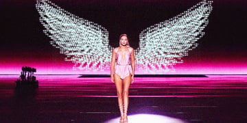 woman in shiny short pyjama on podium with digital angel wings