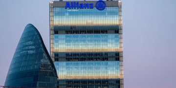 Allianz blue sign on top of glass building, blue sky