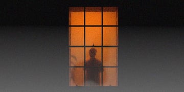 A dark silhouette through an orange window.
