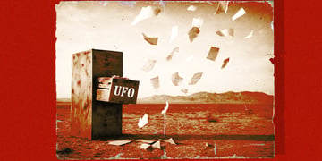 A retro shot of a filing cabinet out in the desert, with paper blowing out of it.