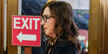 Linda Yaccarino next to exit sign
