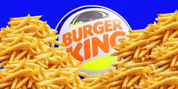 The Burger King logo surrounded by mounds of french fries.