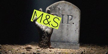 m&S in black letters, yellow background, tombstone, R.I.P, sandy hand, gravel