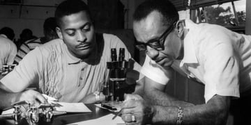 A black and white photo of professors in the lab.