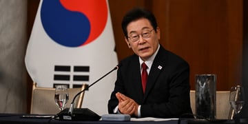 south korean president in black suit and white shirt