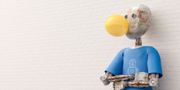 white muddy ai bot, white brick wall, blue tshirt, yellow bubble
