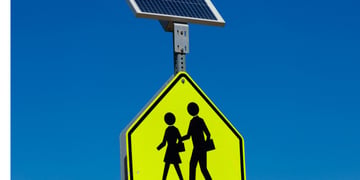 yellow traffic sign, woman and daughter silluet walking, solar power battery
