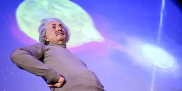 A wax model of Einstein next to a black hole exhibit.