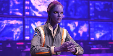 purple alien as news anchor in blue tv studio