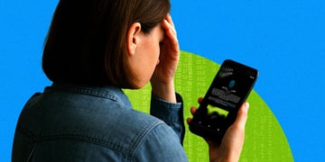A disconcerted parent worrying as a data breach happens on her phone.