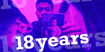 A parent showing their son as a baby and displaying a photograph in China.