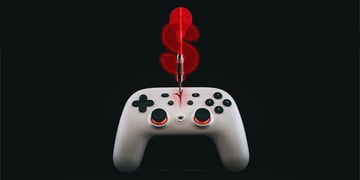 white gaming controller, red arrow in the middle of it, red dollar sign