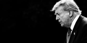 A black and white photo of President Donald rump in the darkness.