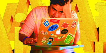 An employee looking at their laptop with letters AI in the background