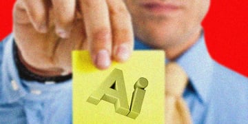 An office worker holds a sticky note that says AI
