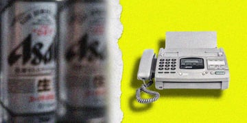 A blurred can of Asahi and a fax machine.
