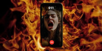 A terrified victim on the phone screen in the blaze of a fire.