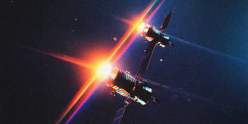 Two space satellites, passing each other, like ships in the night.