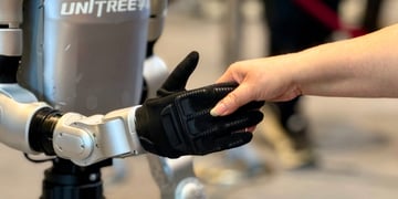 Unitree humanoid robot shaking hands with a human